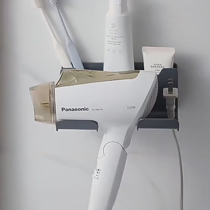 Black wall-mounted DryDock hair dryer holder holding a corded hair dryer